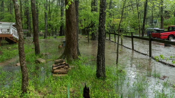 Stream overflowing and flooding yard after a rainstorm — Stock Photo, Image