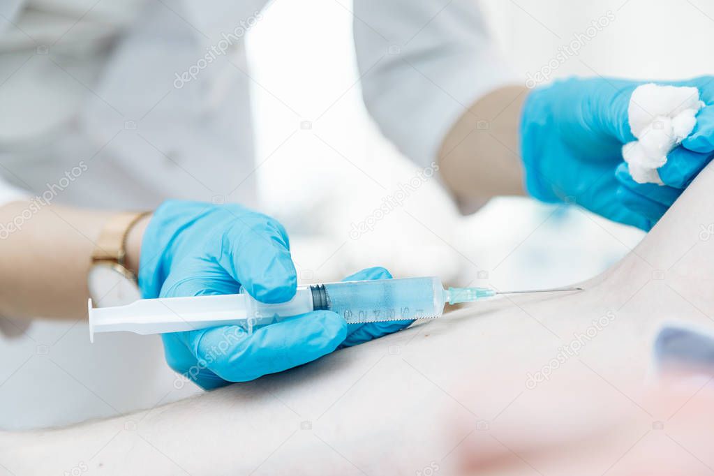 Close-up hand's doctor or nurses are vaccination to patient using the syringe injected arm for treated,Doctor giving an injection to a patient