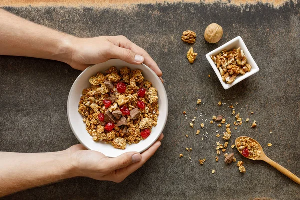 Bowl of granola with dried berries, walnuts and chocolate. Stock Picture