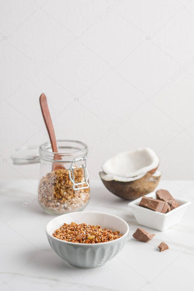 Close-up view of bowl with granola with coconuts and chocolate
