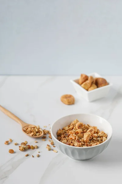 Two wooden bowls of granola on white marble table Royalty Free Stock Photos