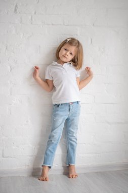 Ayakta ve beyaz arka plan üzerinde poz elbiseli güzel küçük kız tam uzunlukta