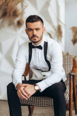 Aynanın yanındaki evde yakışıklı damat. Genç damat hazırlanıyor. Nişanlısı sabah evde. Düğünden önce damat hazırlığı.