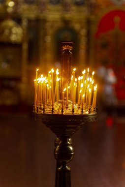 İnce sarı yanan mumlar. Kilise mumları.