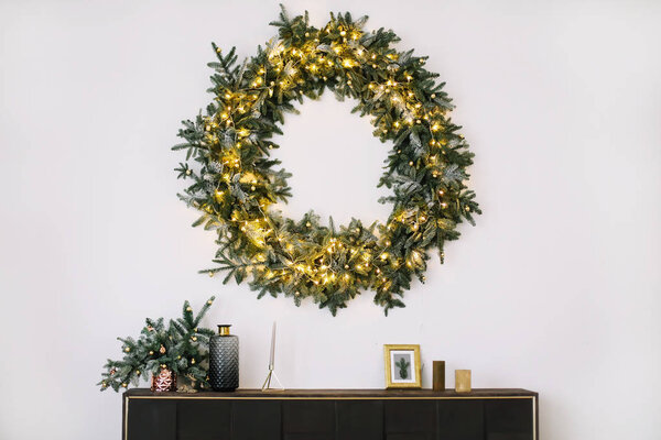 New Year's interior.  Wreath of spruce  with garland. Christmas decorations 