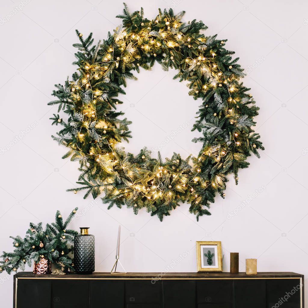 New Year's interior. Wreath of spruce  with garland. Christmas decorations 