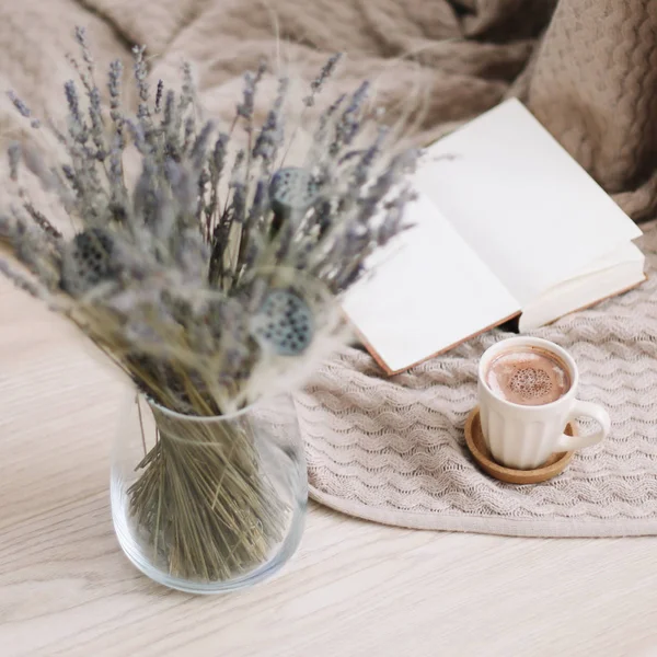 stock image  Dried flowers and a cup of cappuccino  with book on wooden background. top view. flatlay