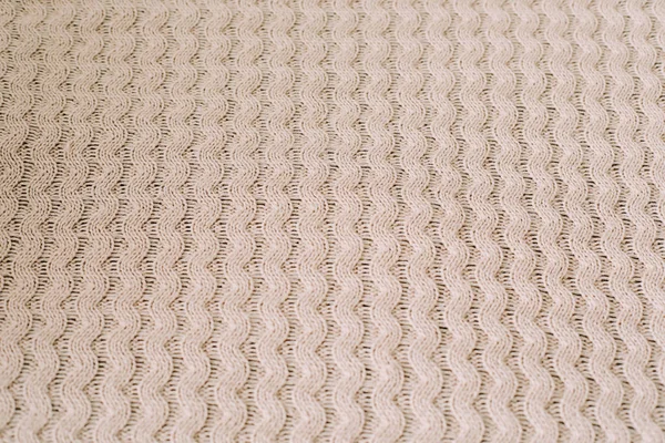 Knitted background. Knitting pattern of wool. Knitting. Texture of knitted woolen  fabric for wallpaper and an abstract background — Stock Photo, Image