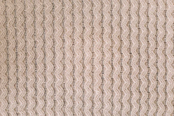 Knitted background. Knitting pattern of wool. Knitting. Texture of knitted woolen  fabric for wallpaper and an abstract background