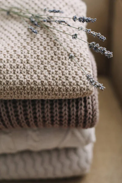 Montón de cuadros de lana sobre un fondo claro. Montón de ropa de punto (suéteres, bufandas, pullovers ). — Foto de Stock