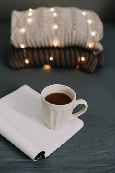 Wool beige sweater, warm knitted plaid, a book and coffee cup. Breakfast in bed. Sweet home. flat lay, still life — Stock Photo, Image