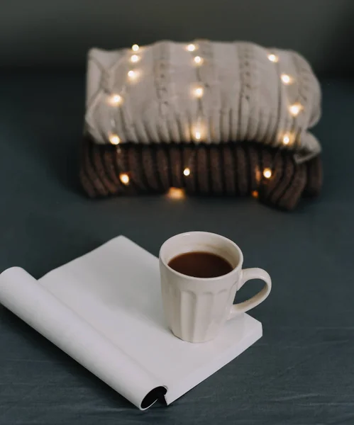 Wool beige sweater, warm knitted plaid, a book and coffee cup. Breakfast in bed. Sweet home. flat lay, still life — Stock Photo, Image