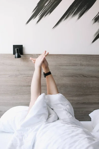 Male hands expressing enjoyment or pleasure under white bedsheets. Hands in bed with white linens. Minimal happy morning concept. — Stock Photo, Image