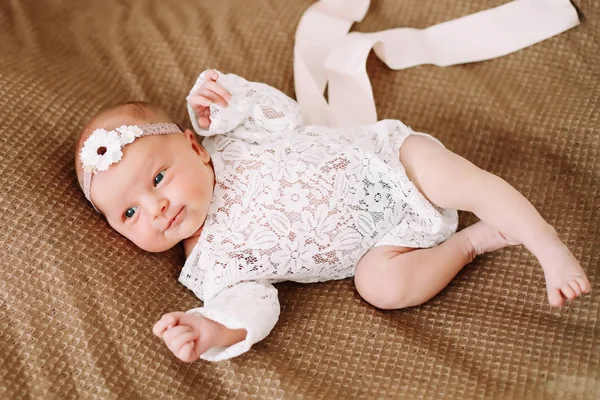 Primo piano bella neonata su una coperta. Un ritratto di una bellissima neonata che indossa un cerchietto. Primo piano foto — Foto Stock
