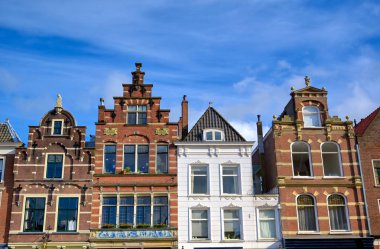 Güneşli bir günde Hollanda'nın Delft şehrinde sokaklar boyunca mimari.