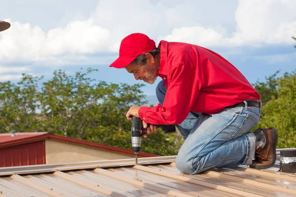 Contractor, builder installing metal panel roof
