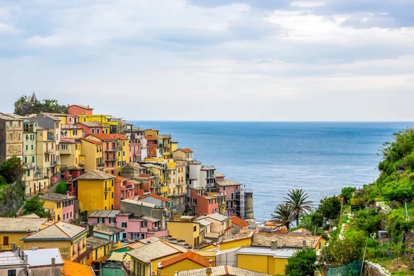 beach streets and colorful houses on the hill in Manarola in Cinque Terre in Italy