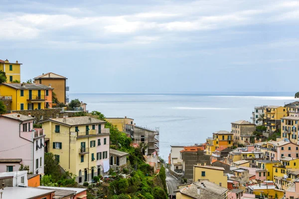 beach streets and colorful houses on the hill in Riomaggiore in Cinque Terre in Italy