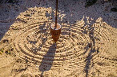 Mathematical pendulum is drawing on the sand. clipart