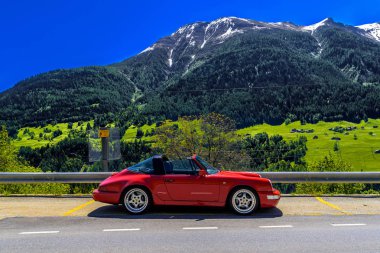 FILET, SWITZERLAND - APR 2017: Red Porsche 911 993 cabrio in Swiss Alps, Moerel, Filet, Oestlich Raron, Wallis Valais Switzerland