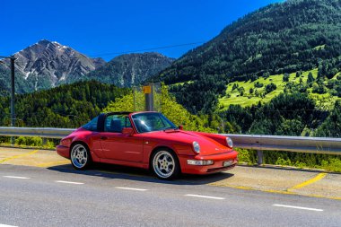 FILET, SWITZERLAND - APR 2017: Red Porsche 911 993 cabrio in Swiss Alps, Moerel, Filet, Oestlich Raron, Wallis Valais Switzerland