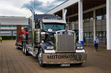 FRIEDRICHSHAFEN - MAY 2019: black KENWORTH W900 1961 conventional-cab truck at Motorworld Classics Bodensee on May 11, 2019 in Friedrichshafen, Germany clipart