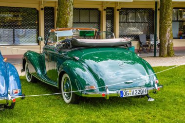 Baden Baden, Almanya - Temmuz 2019: yeşil Mercedes-Benz 220 Cabriolet Bir Cabrio Roadster W187 1951 1955, Kurpark 'ta yaşlı adam toplantısı
