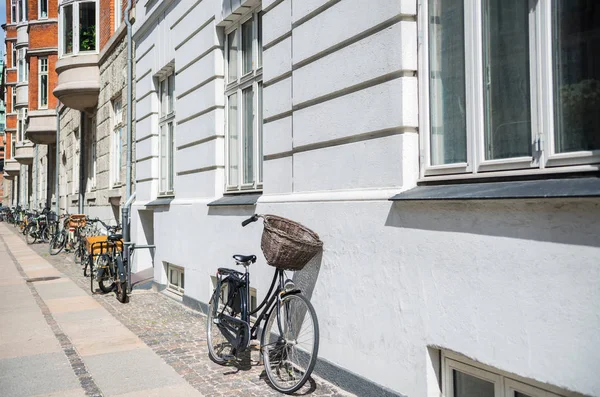 urban scene with bicycles parked on street in copenhagen, denmark