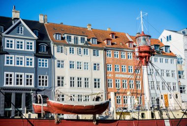 COPENHAGEN, DENMARK - 06 MAY, 2018: Nyhavn pier with buildings and boats in the Old Town of Copenhagen, Denmark   clipart