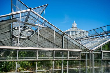 COPENHAGEN, DENMARK - MAY 6, 2018: greenhouses and Palm house in botanical garden  clipart