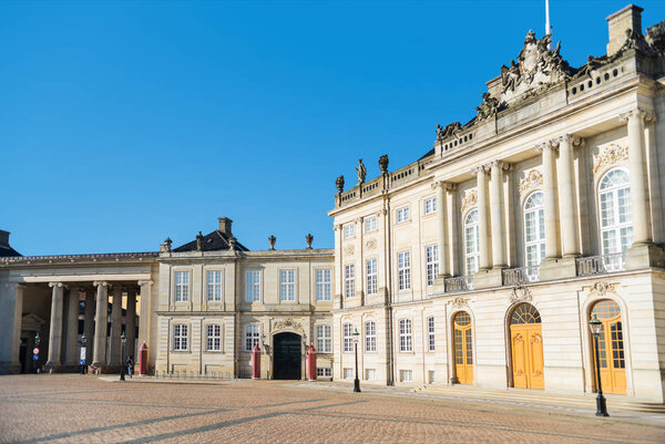 beautiful Amalienborg Square with historical buildings and columns at sunny day, copenhagen, denmark