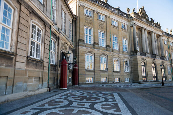 old buildings with columns and decorations on historical Amalienborg Square in copenhagen, denmark