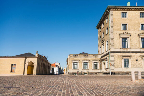 empty square with pavement and historical buildings in pavement, denmark