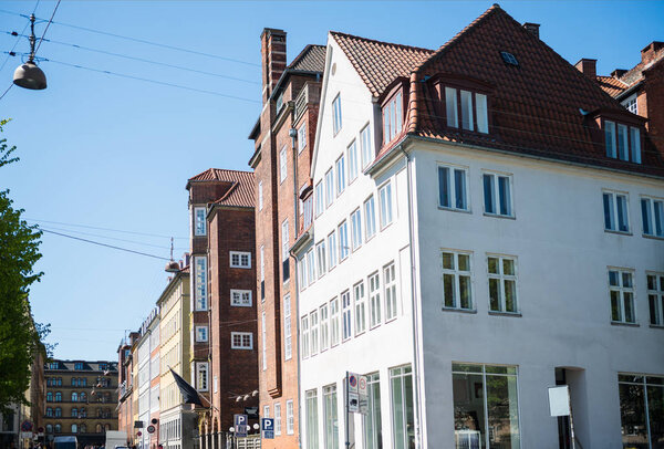 low angle view of beautiful houses and street at sunny day in copenhagen, denmark