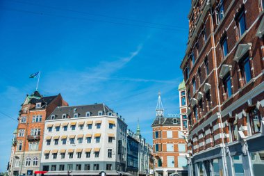 cityscape with buildings under bright blue sky in Copenhagen, Denmark clipart