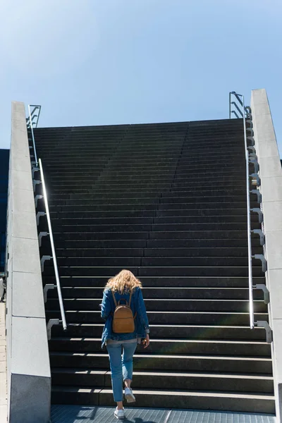 Back view of woman going up on steps in copenhagen, denmark — Stock Photo