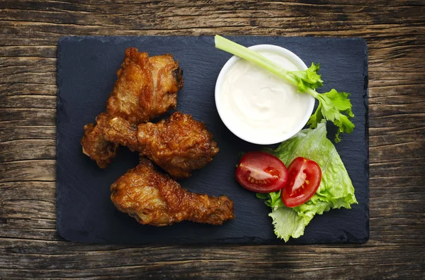 Fried chicken drumsticks and vegetables, top view