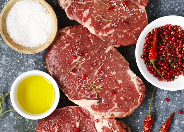 Raw Fresh Meat Ribeye Steak Rosemary Pepper Sea Salt Stone — Stock Photo, Image