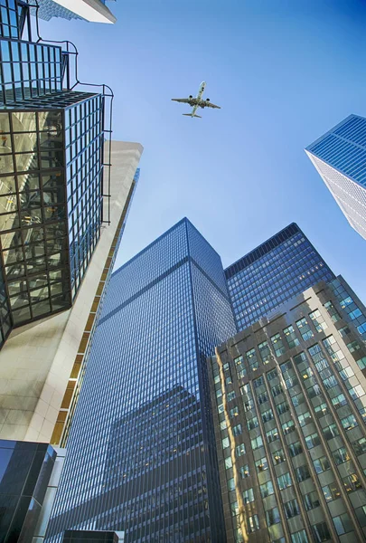 Ett flygplan flyger overhead Toronto skyskrapor. Skyskrapor i t Royaltyfria Stockfoton