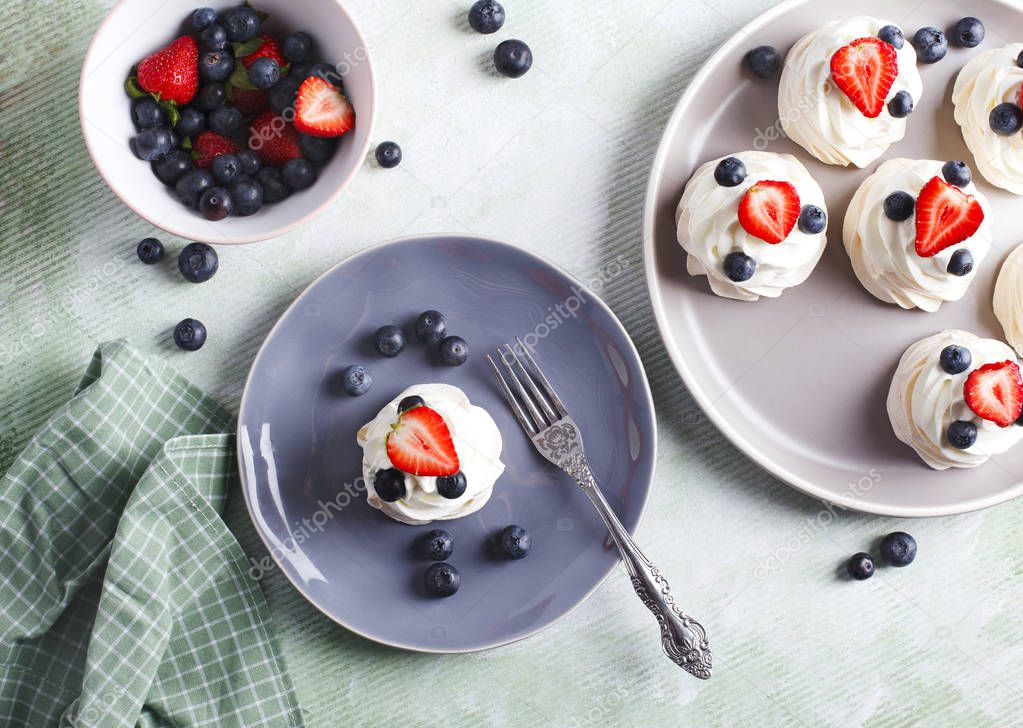 Mini Pavlova meringue with whipped cream and blueberries and str