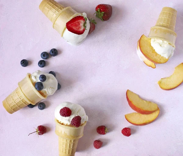 Vanilla ice cream flavor in cones with summer berries and fruits