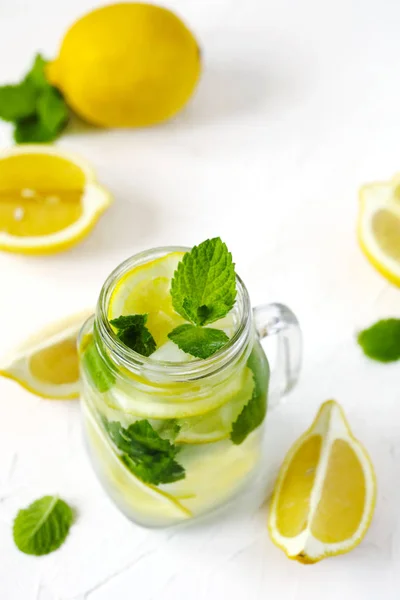 Mason jar glass of lemonade with mint on white background