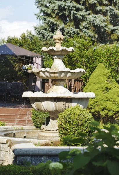 Splashing fountain in the summer garden — Stock Photo, Image