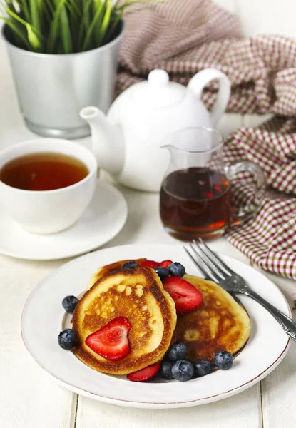 Pancakes with strawberries, blueberries and maple syrup for a br — Stock Photo, Image