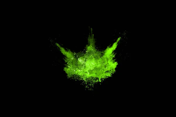 The movement of abstract dust explosion frozen green on black background. Stop the movement of powdered green on black background. Explosive powder green on black background.