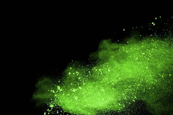 The movement of abstract dust explosion frozen green on black background. Stop the movement of powdered green on black background. Explosive powder green on black background.