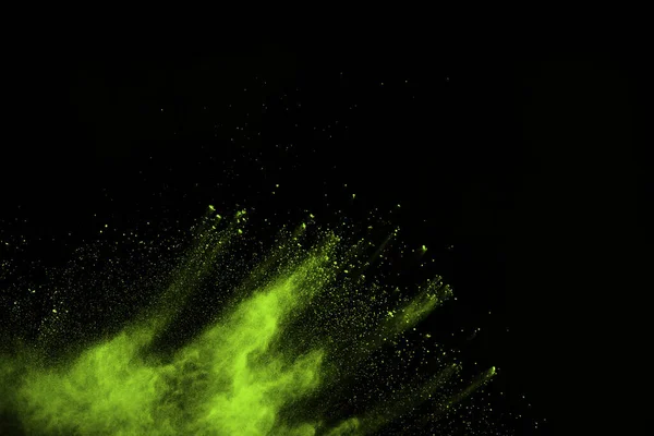 The movement of abstract dust explosion frozen green on black background. Stop the movement of powdered green on black background. Explosive powder green on black background.