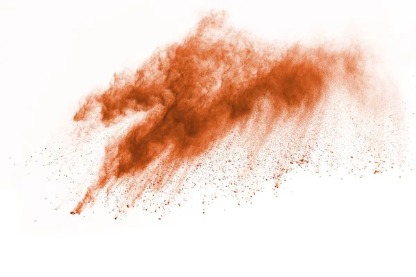 Brown color powder explosion on white background. Colored cloud. Colorful dust explode. Paint Holi.