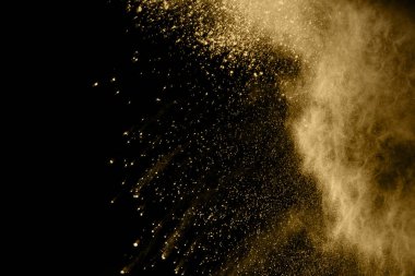 Siyah arka planda altın tozu patlaması. Renkli bulut. Renkli toz patlar. Boya Holi.