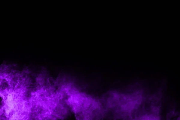 The movement of abstract dust explosion frozen purple on black background. Stop the movement of powdered purple on black background. Explosive powder purple on black background.